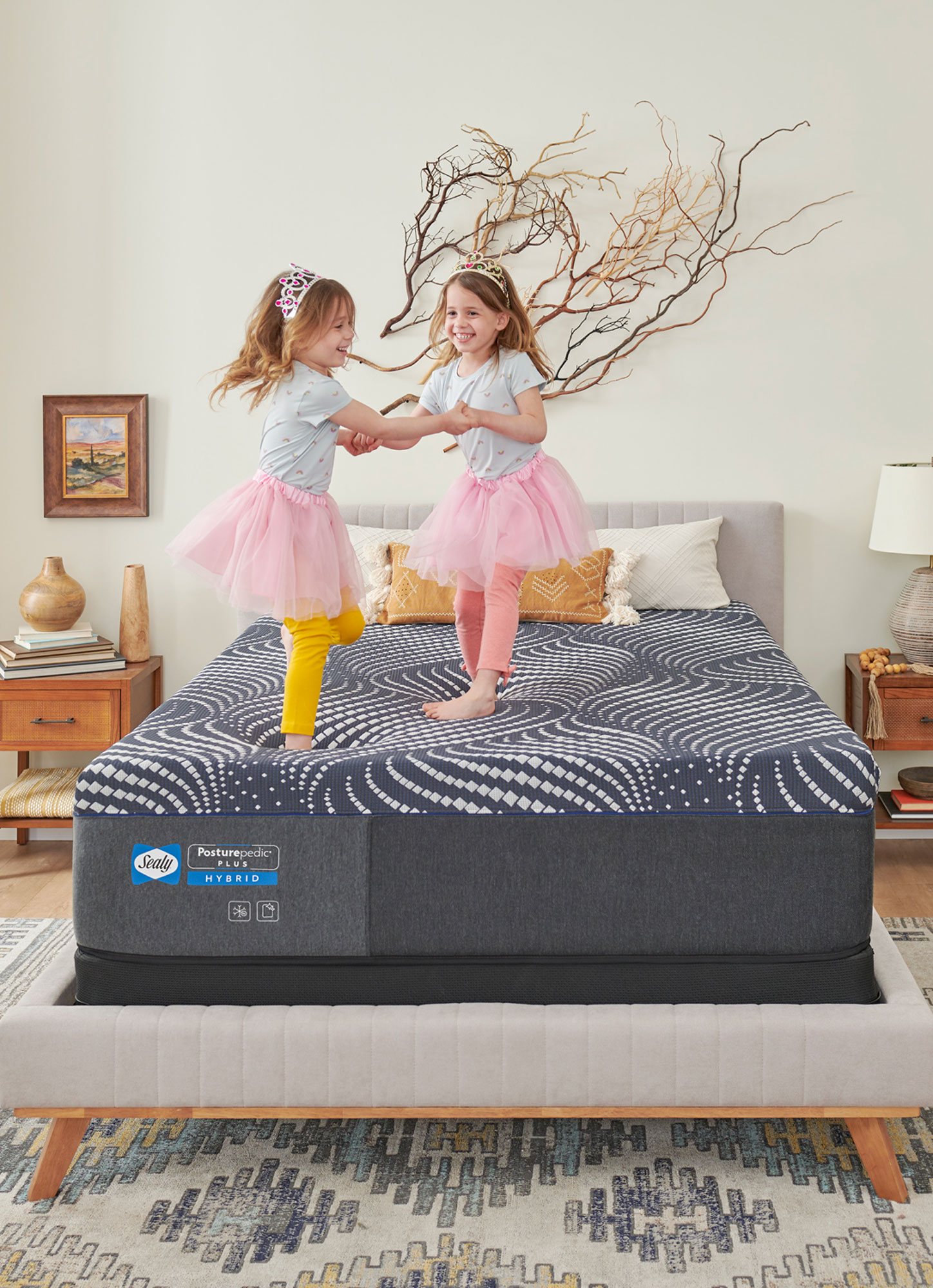 Young girls jumping on Sealy mattress